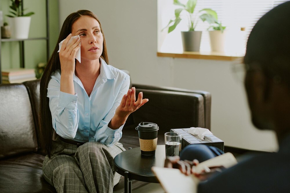 crying-young-woman-sitting-therapy-session_249974-25057.jpg