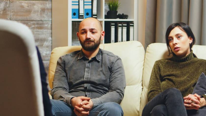 young-man-breathing-heavily-sitting-couch-with-his-wife-couple-therapy-talking-about-their-relationship_482257-25234.jpg